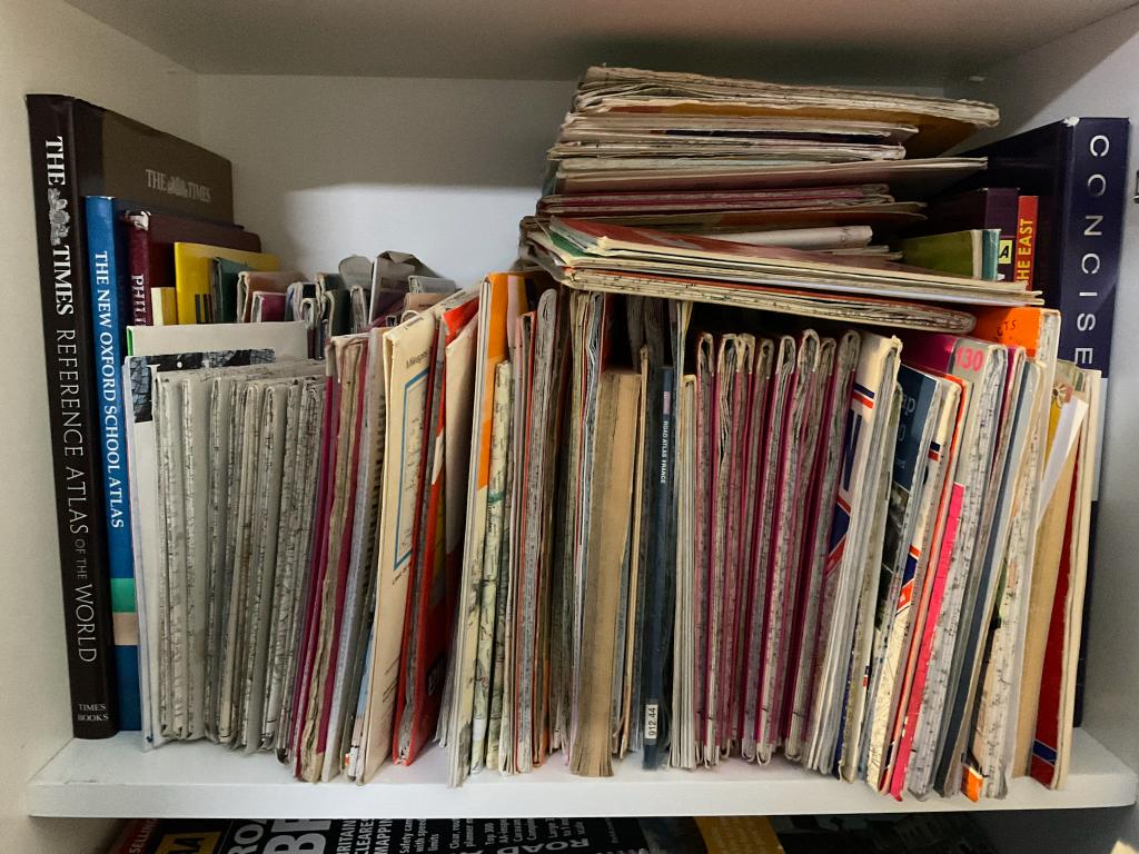 Shelf of vintage maps and atlases in the Pixies & Sprites workshop